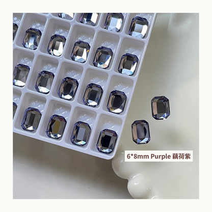 Clear octagon K9 flat back rhinestones purple 6x8mm shown on tray and single piece for nail art use
