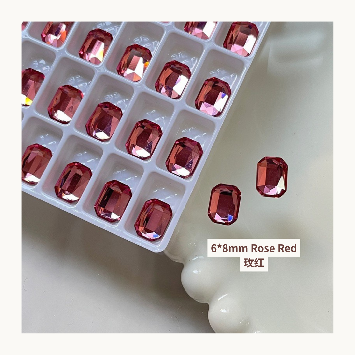 Clear octagon K9 flat back rhinestones rose red 6x8mm shown on tray and single piece for nail art use