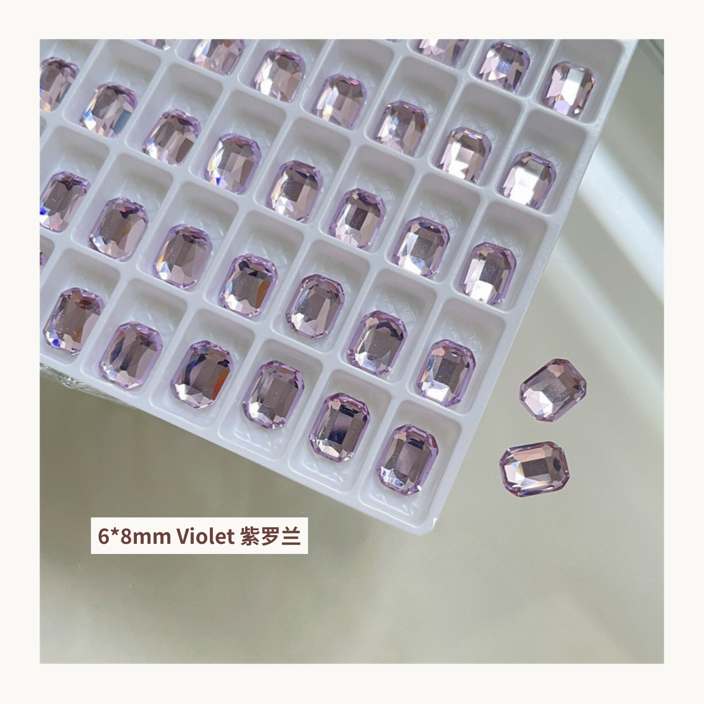 Clear octagon K9 flat back rhinestones violet 6x8mm shown on tray and single piece for nail art use