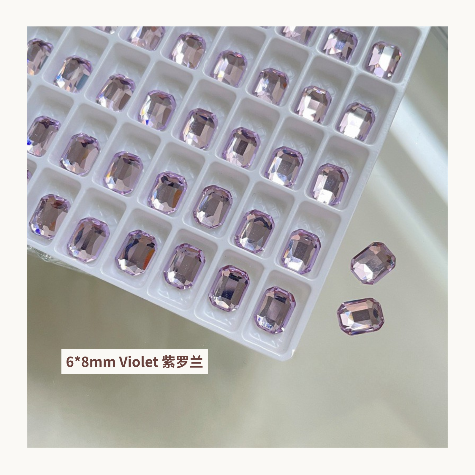 Clear octagon K9 flat back rhinestones violet 6x8mm shown on tray and single piece for nail art use