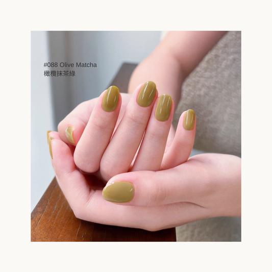 Olive matcha green gel manicure in a warm indoor setting