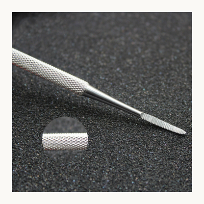Close-up of curved nail file showing textured handle and abrasive end