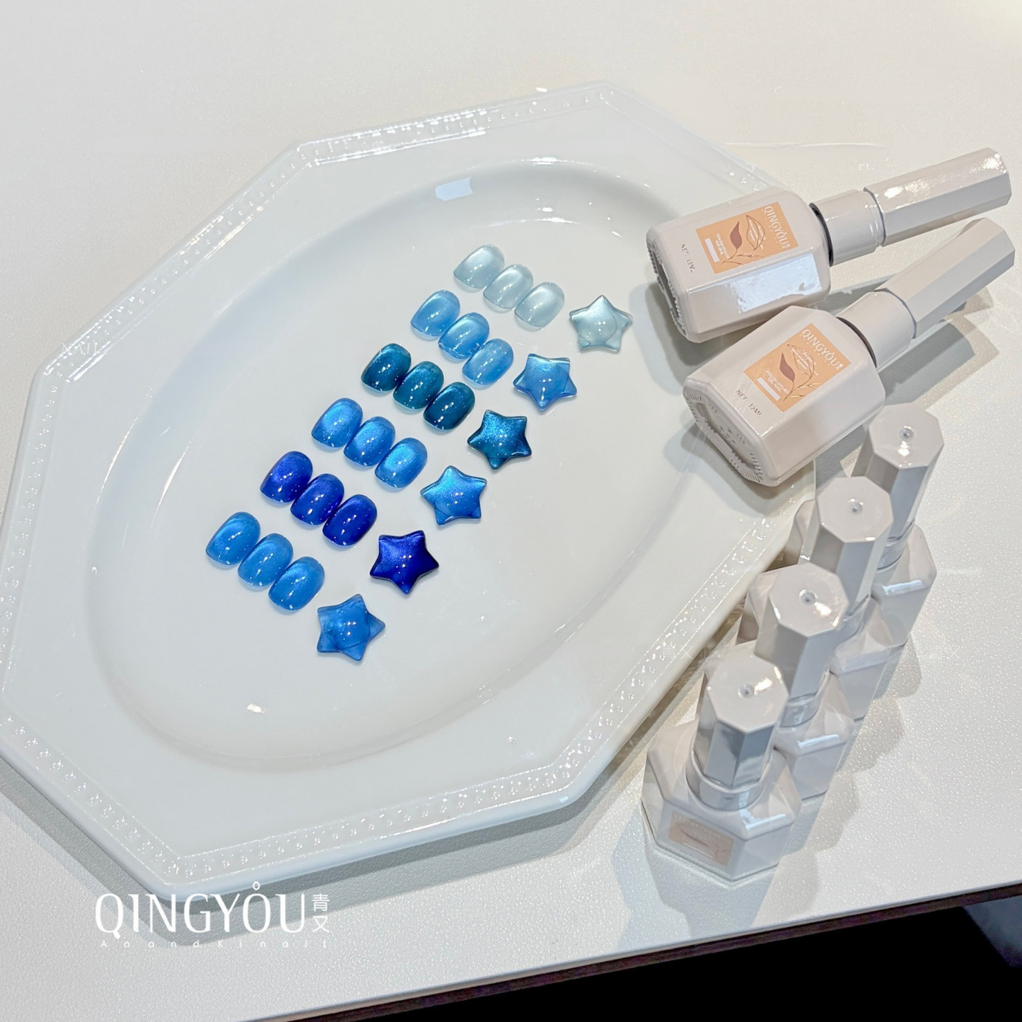 QINGYOU blue gel polish bottles displayed with matching nail swatches