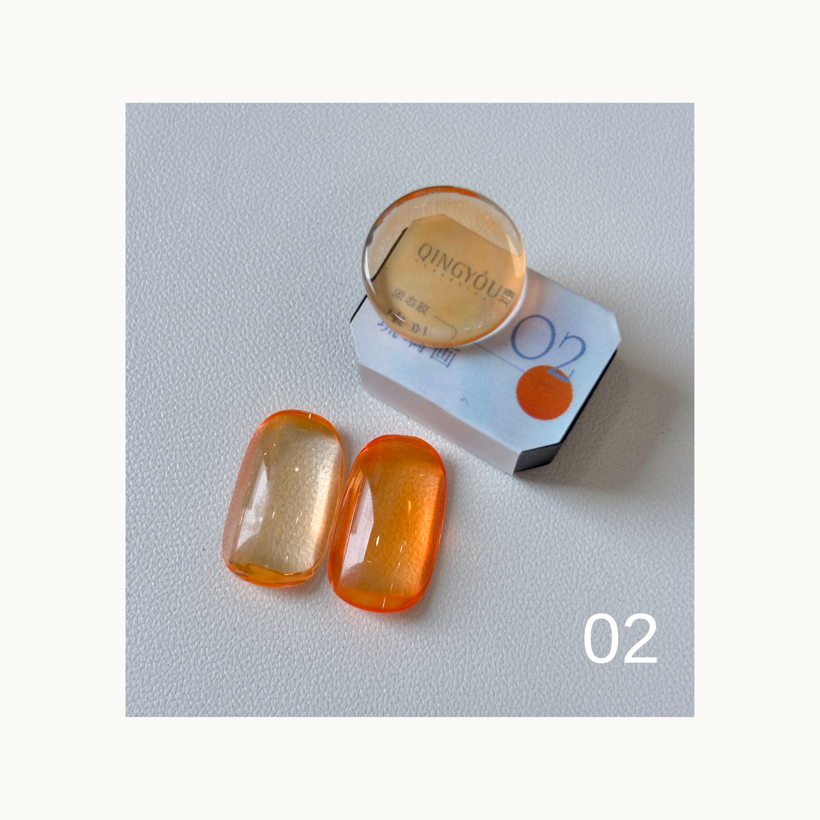 QINGYOU Cube Glass Jelly Painting Gel 02 Orange translucent glass-effect color swatch with cube and nail tips