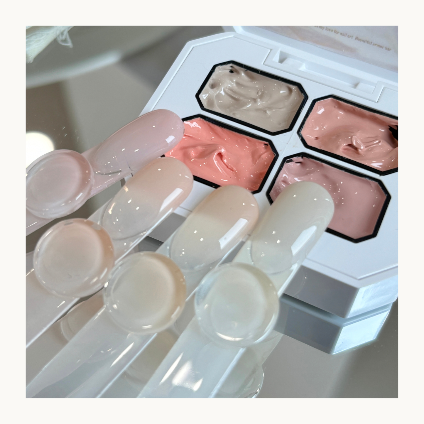 QINGYOU nude 4-grid concealer gel palette with natural nude color nail swatches on display