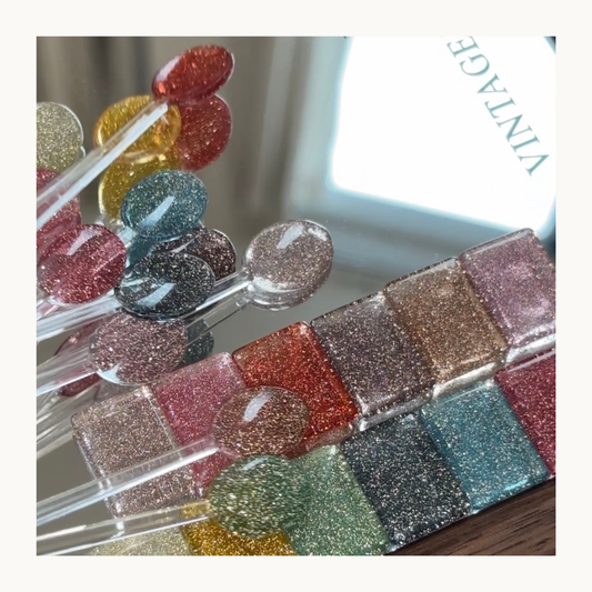 12-shade color chart displaying rainbow diamond glitter gel colors for nail art.