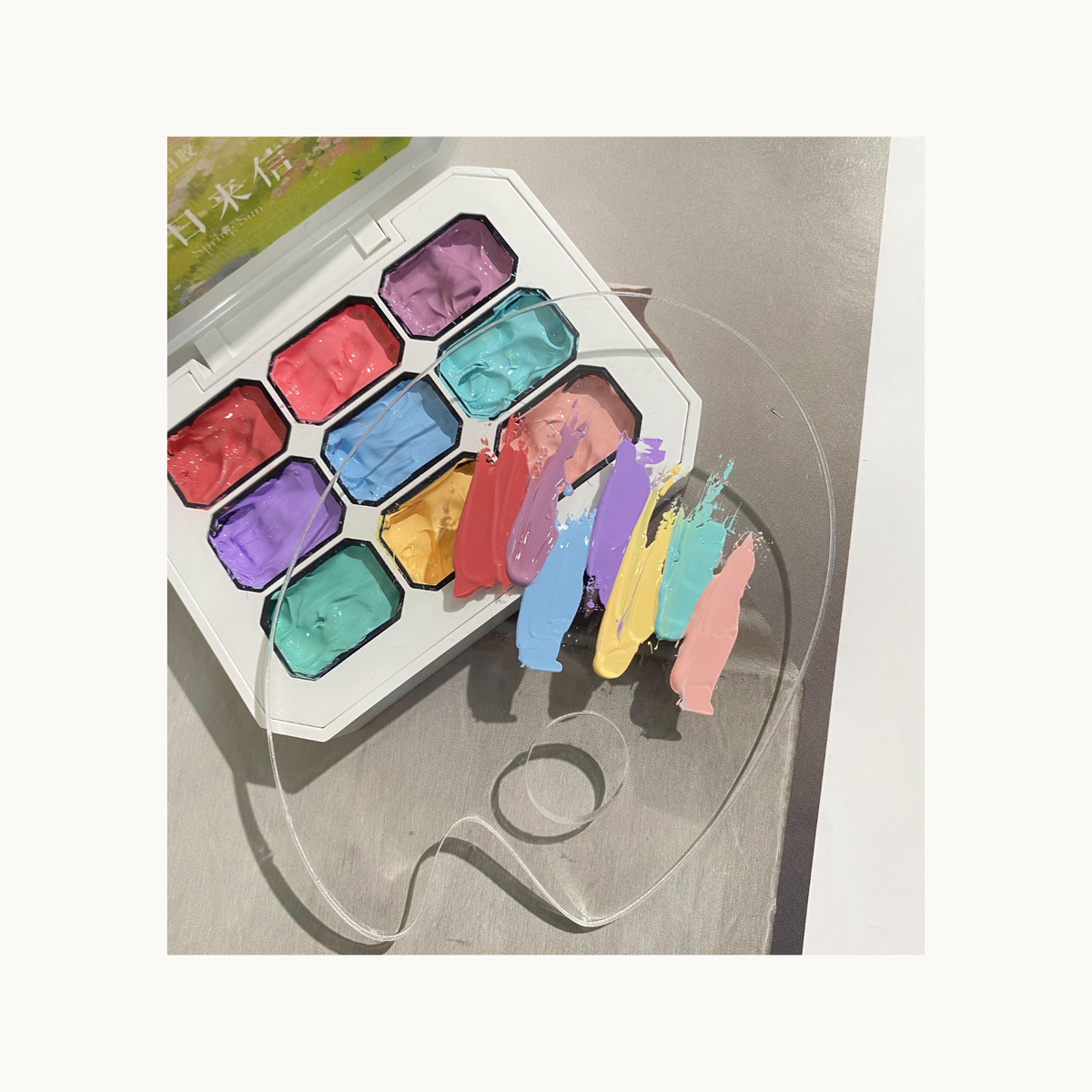 QINGYOU pastel gel palette with colorful paint strokes on a clear sheet