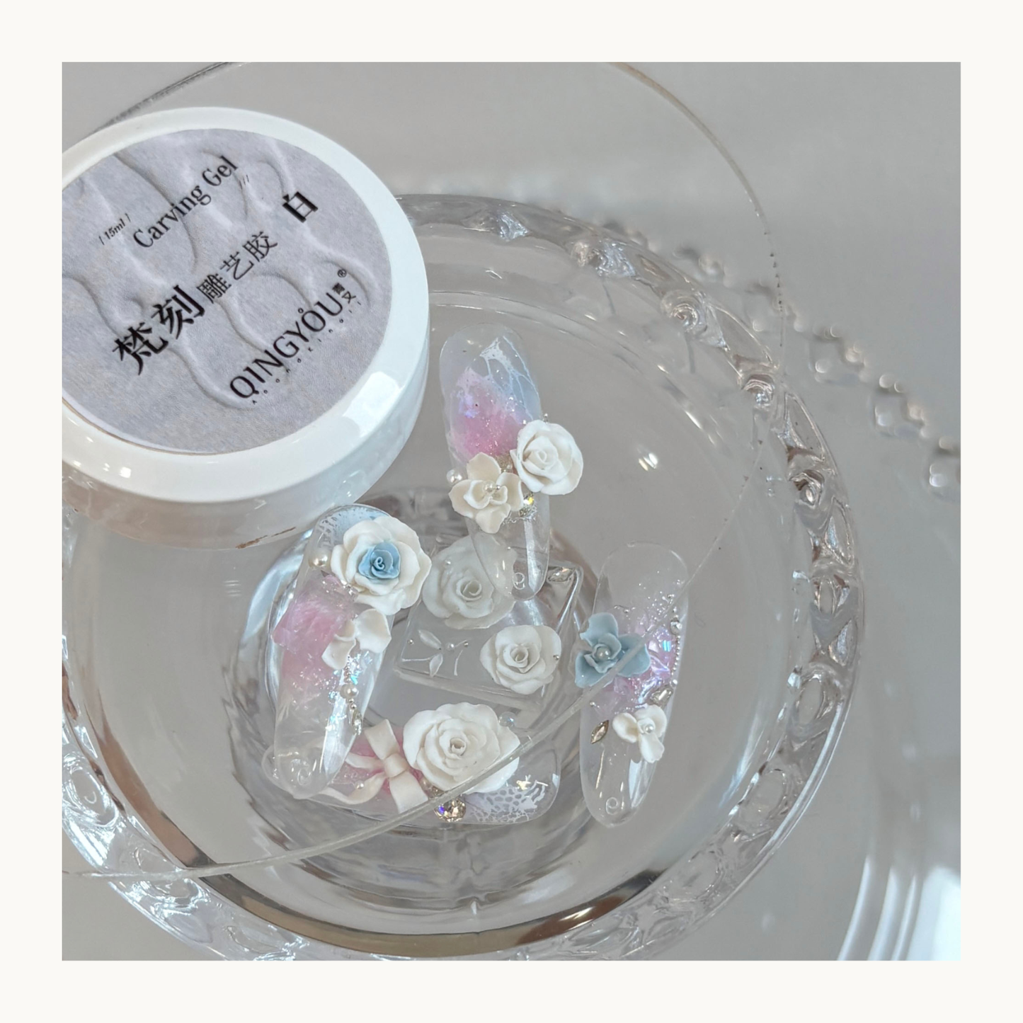 QINGYOU white relief carving gel with 3D floral nail art samples displayed on a clear plate
