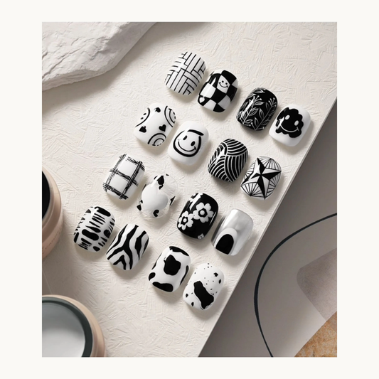Black and white nail art featuring checks, florals, smiley faces, animal prints and abstract patterns created with TAYE painting gel.