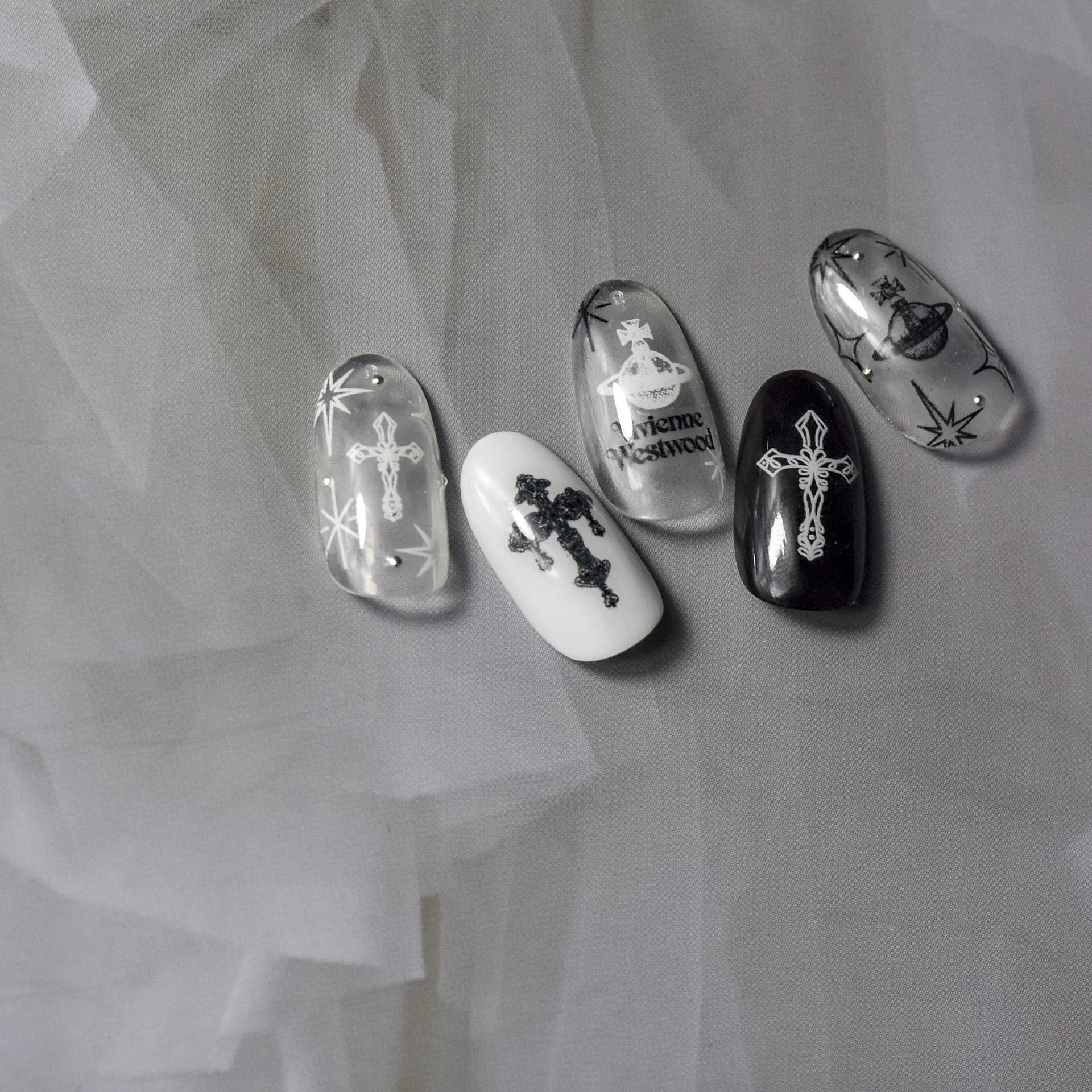 Black and white celestial cross nail art stickers on monochrome nails