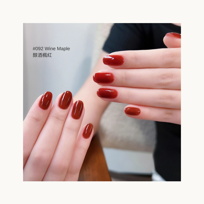 wine-toned maple red gel polish on oval nail tips