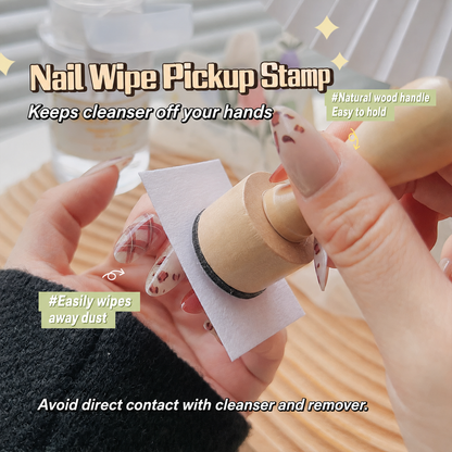 Wooden nail wipe pickup stamp holding a nail wipe