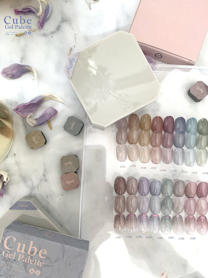 Gel nail palette flat lay with pastel and glitter shade rows