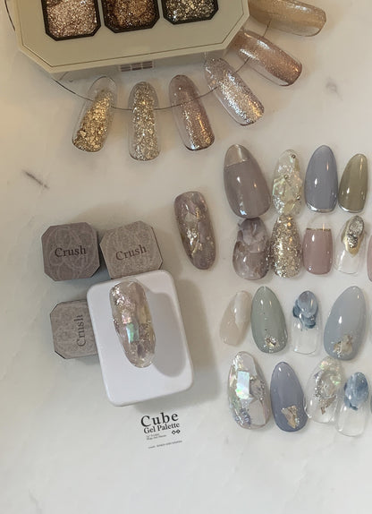 Gel palette display with neutral, blue-gray, and iridescent nail tips
