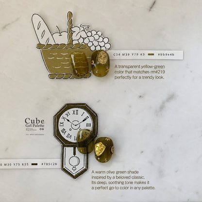 Olive-brown soft gel swatch detail with gold embellishments and color bar