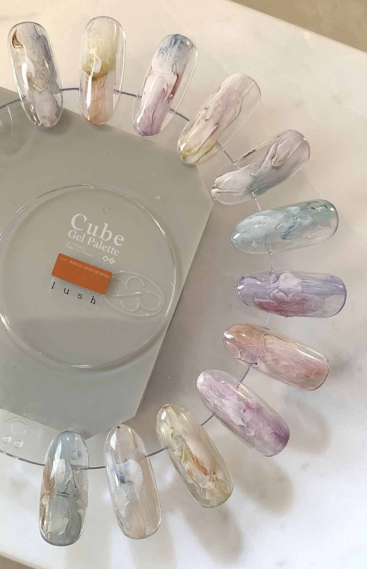 Close-up of translucent marbled soft gel swatches on a clear ring