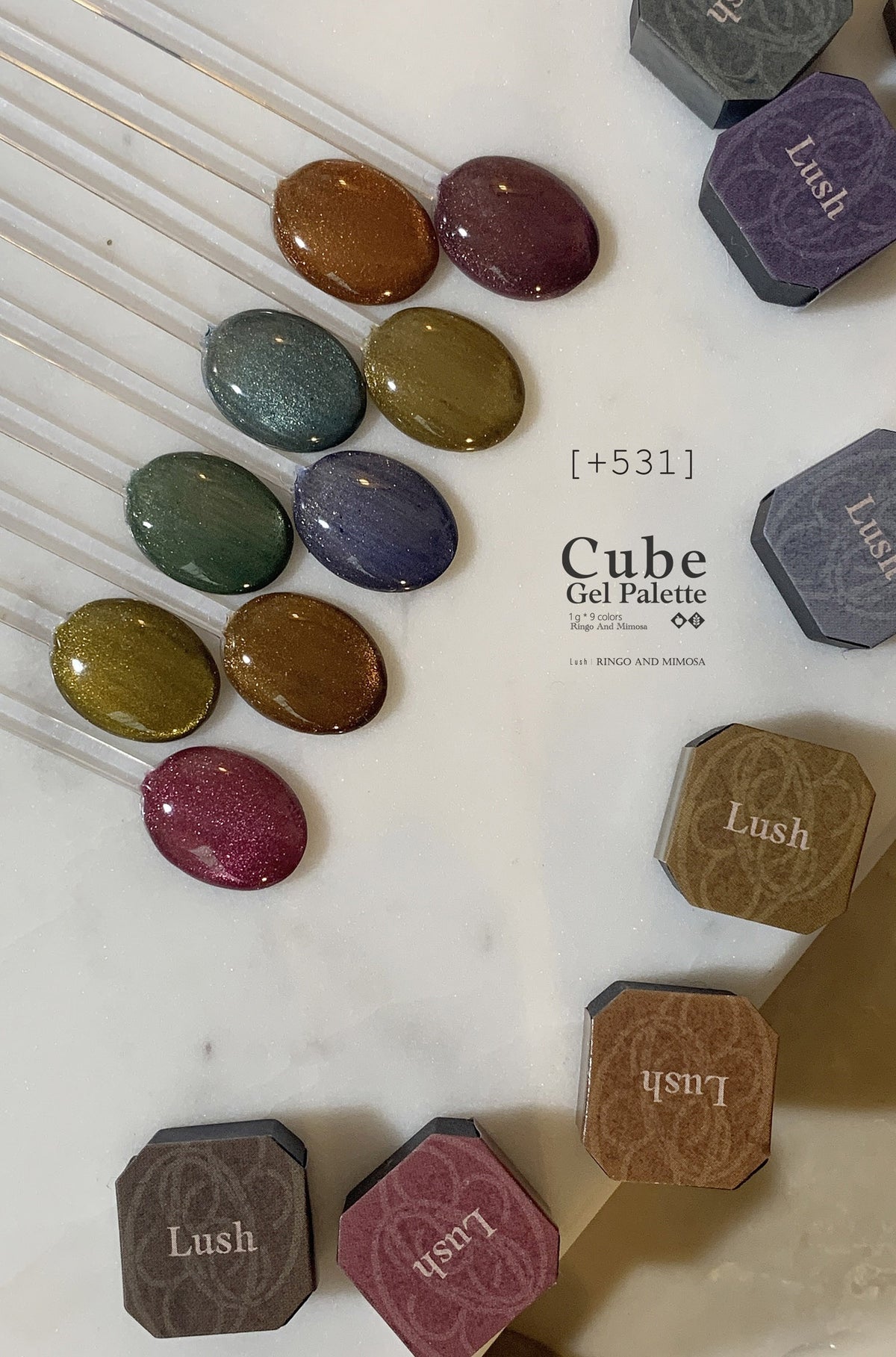 Soft gel color swatches on clear sticks with surrounding palette pans