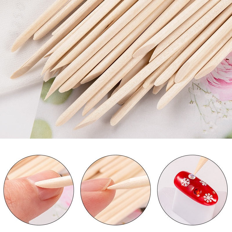 Pointed wooden nail art sticks beside decorated nail examples