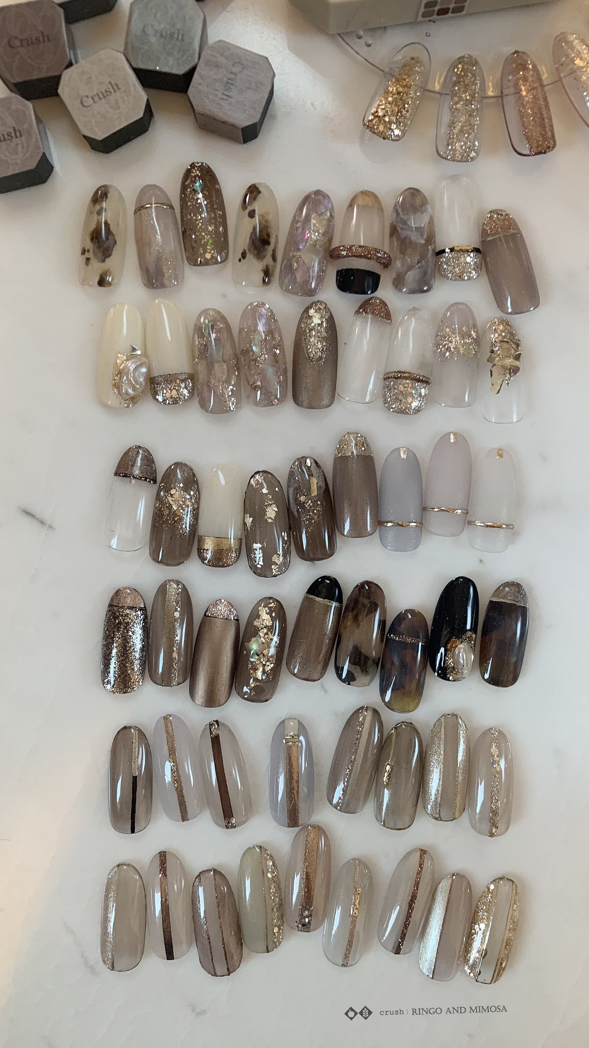 Gel palette with organized rows of decorated nail tips