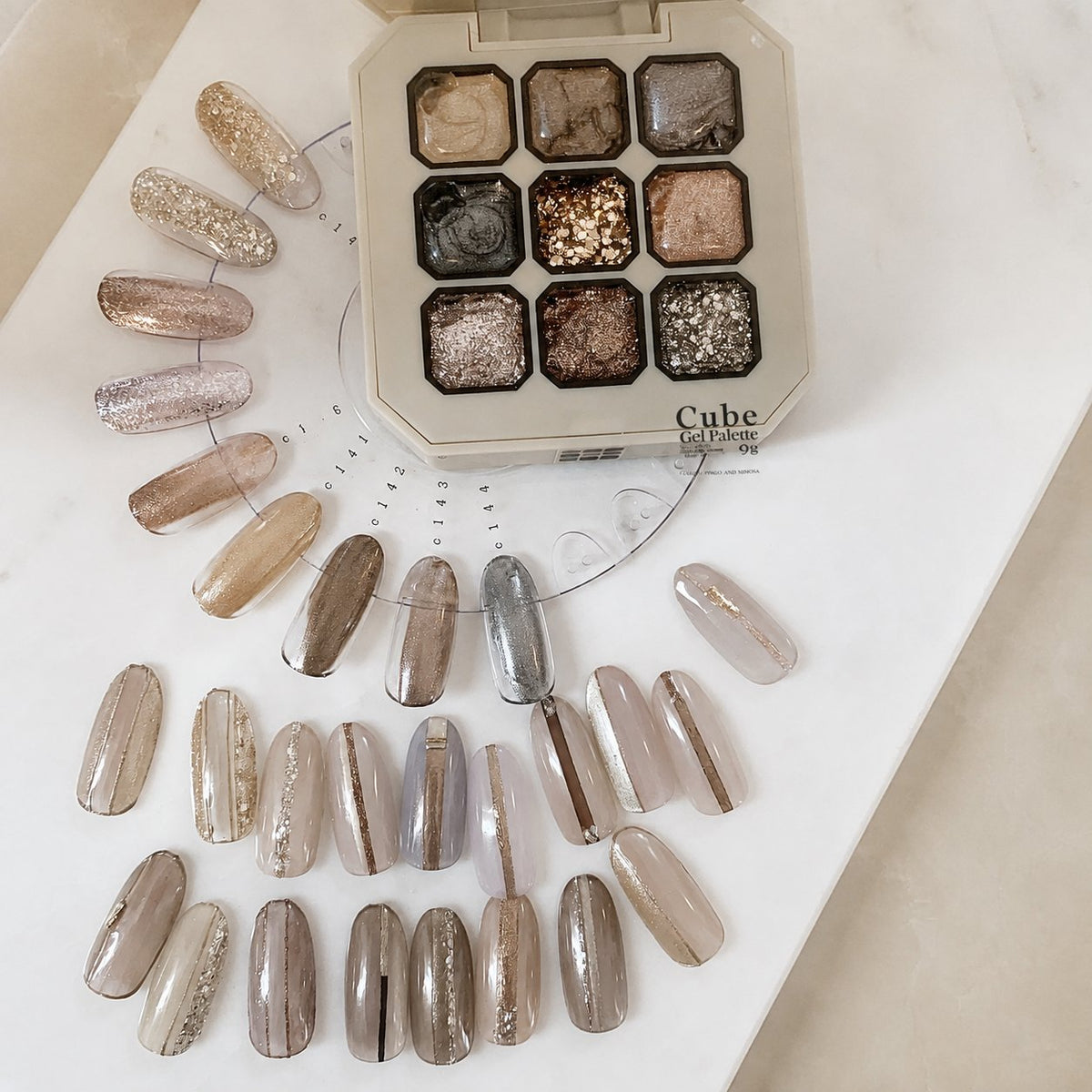 Gel palette with rows of neutral and glitter nail-tip designs
