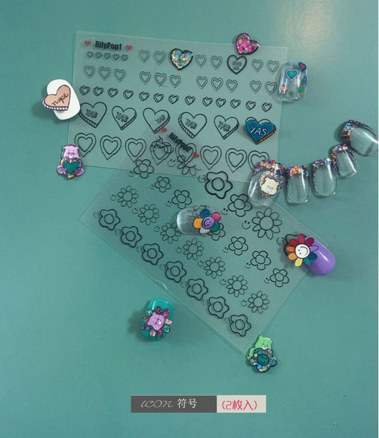 Rily POP FACE sticker detail with heart and flower outlines beside decorated nail tips