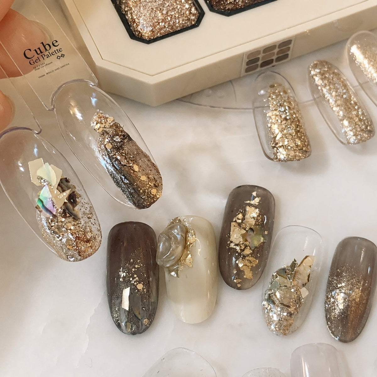 Gel nail-tip display with assorted glitter and foil designs