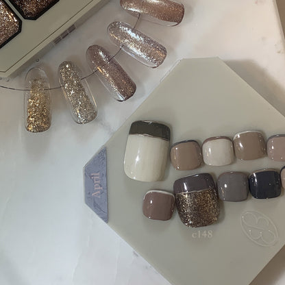 Close-up of neutral gel nail tips beside a small palette