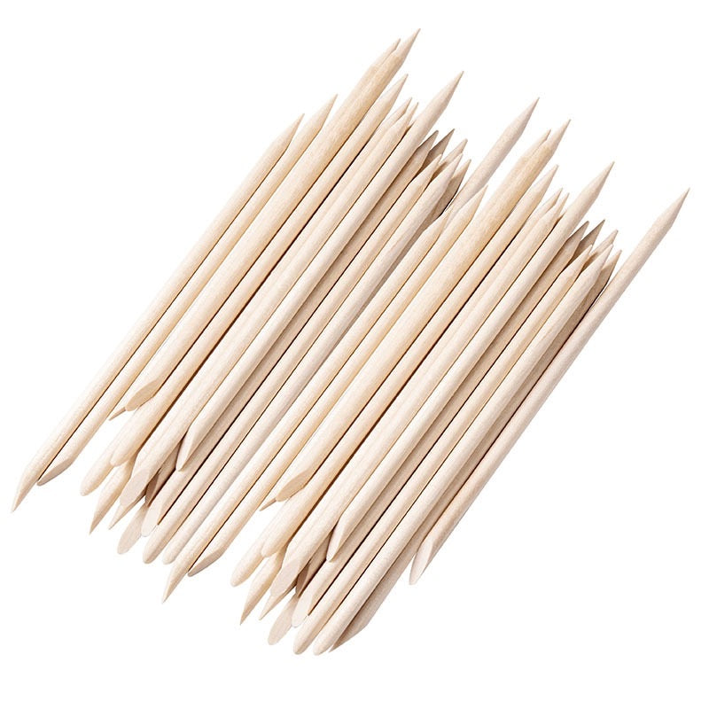 Natural wood nail art sticks with pointed ends arranged diagonally
