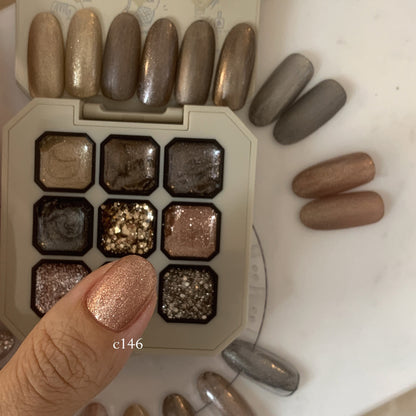 Close-up of rose-gold shimmer gel on a fingernail over the palette