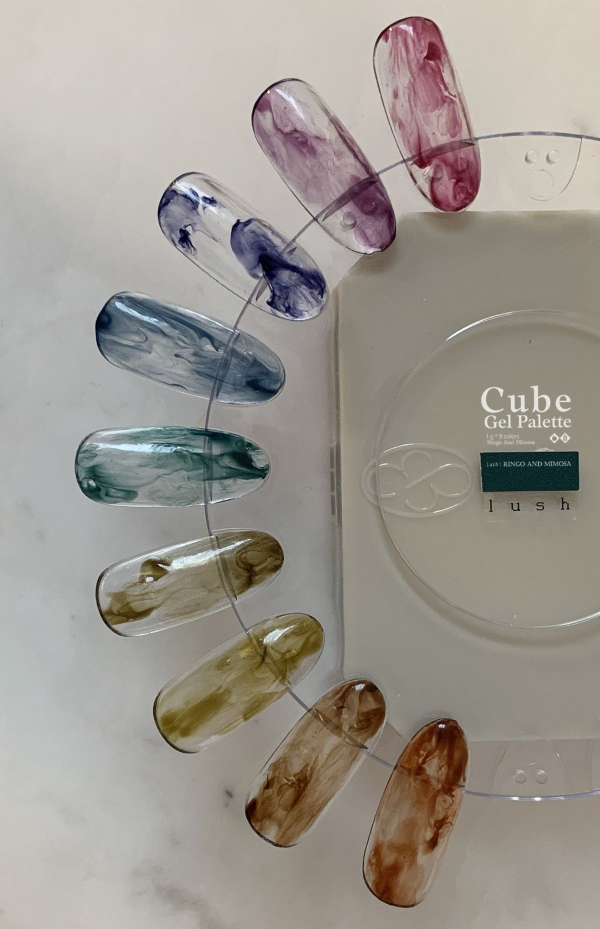 Nine-color soft gel palette on a clear swatch ring