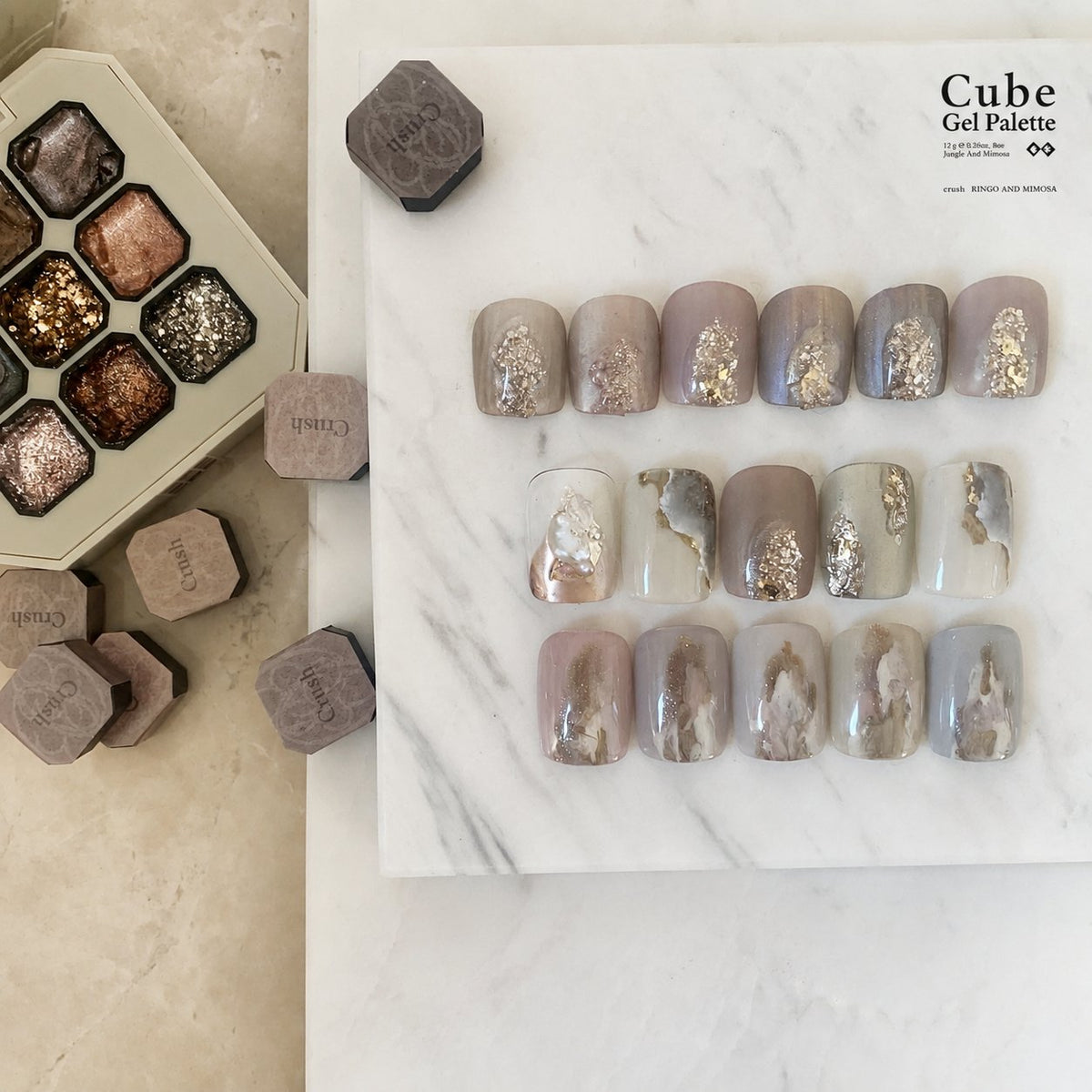 Gel nail-tip shade board with muted colors and foil accents