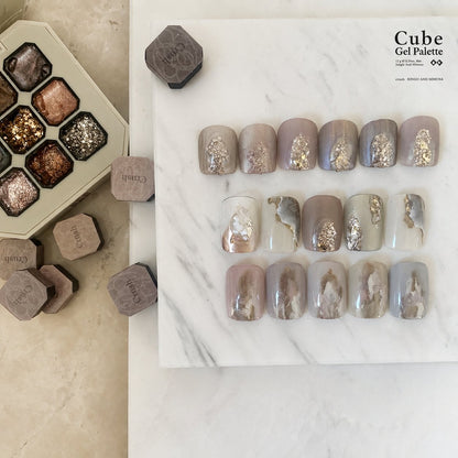 Gel nail-tip shade board with muted colors and foil accents