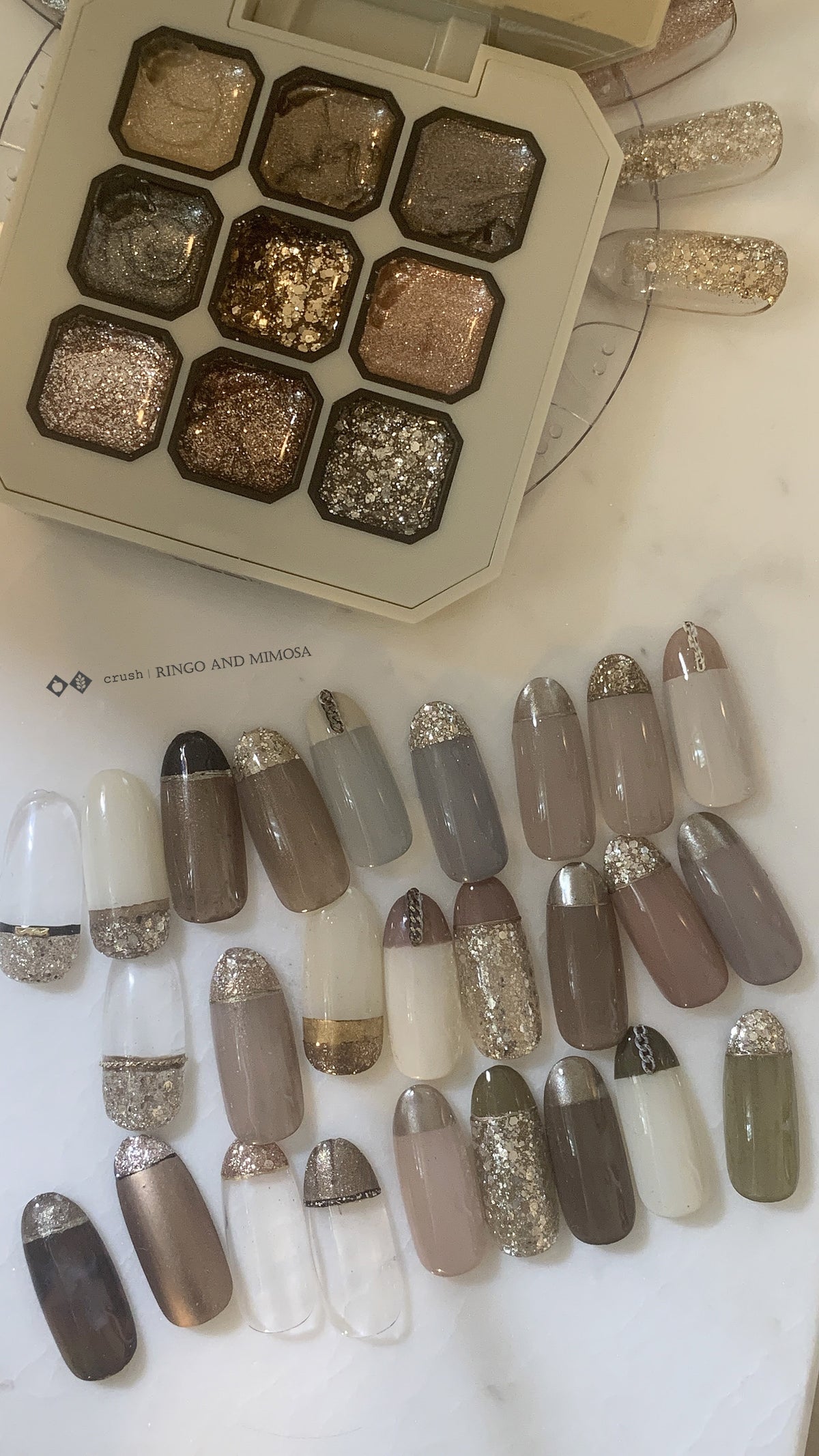 Gel palette shade display with rows of decorated nail tips