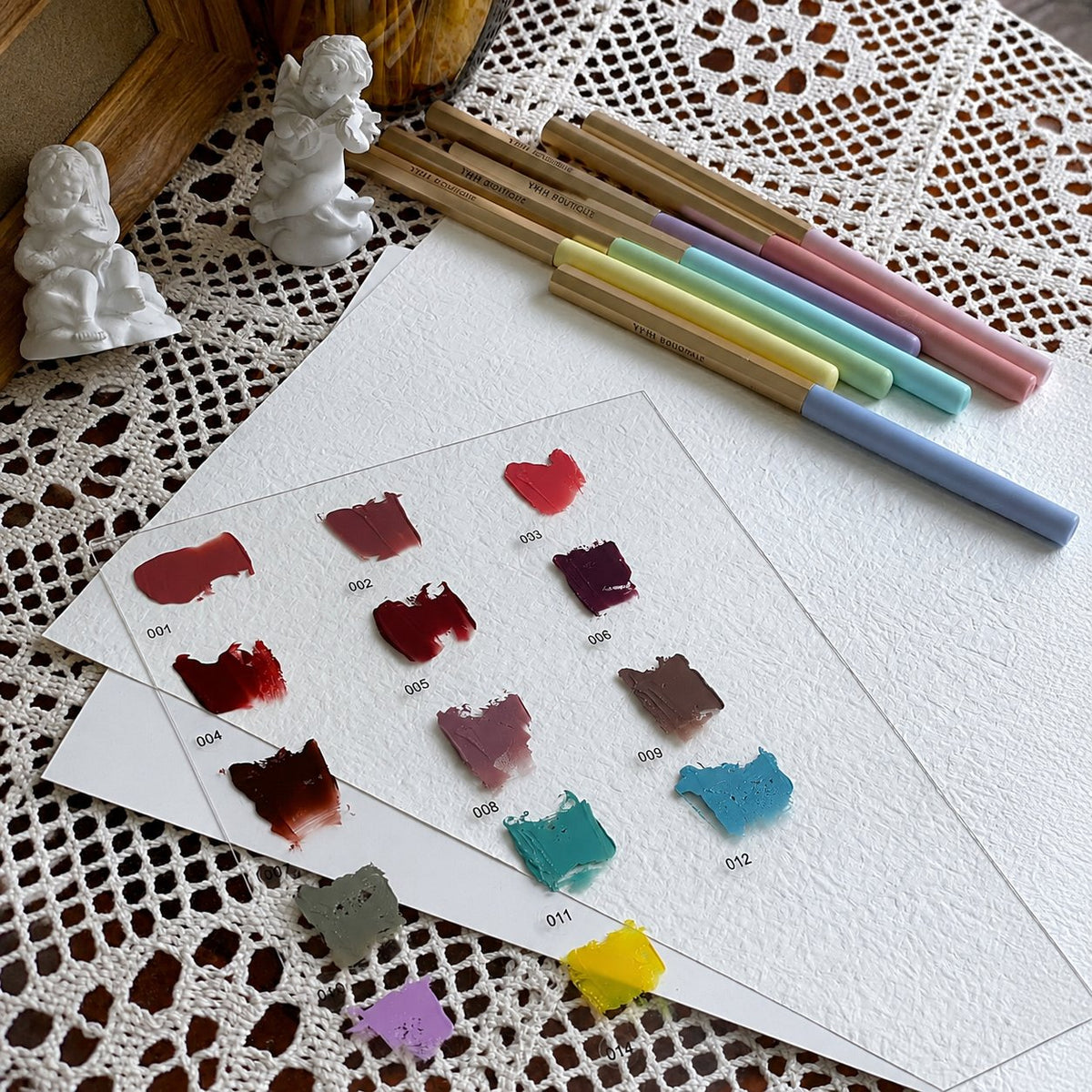 YHH Patting Painting Pot Gel swatch card displayed with pastel nail art brushes.